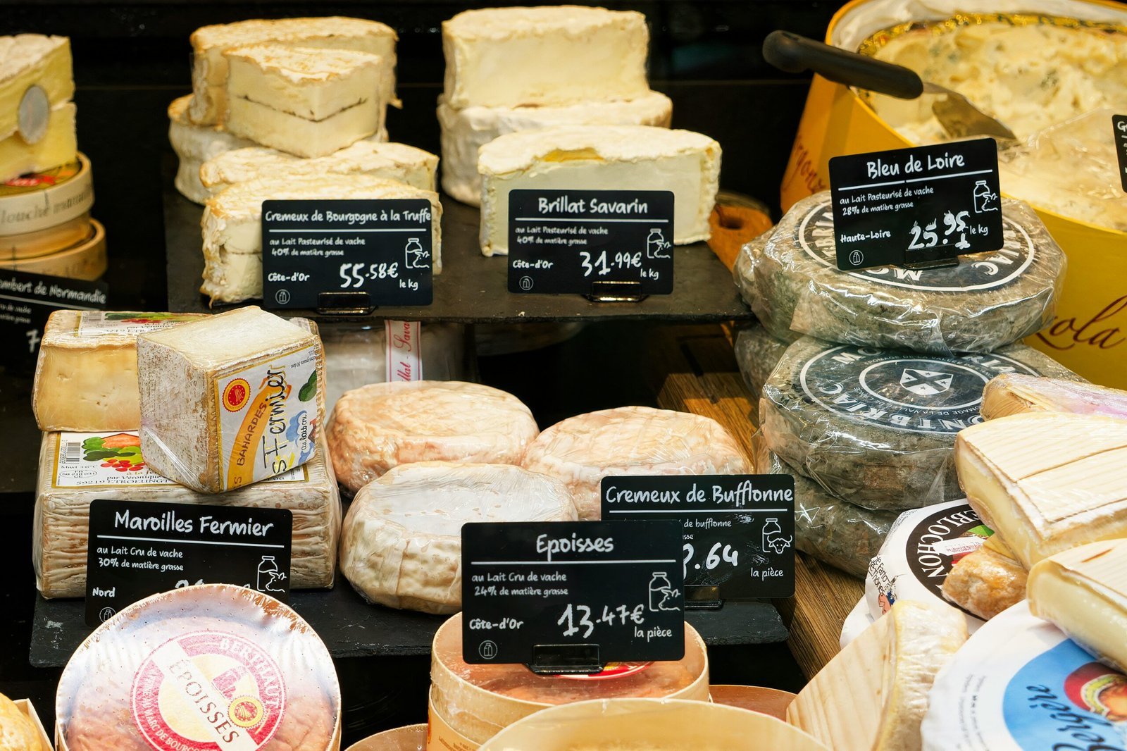 A display case filled with lots of different types of cheese