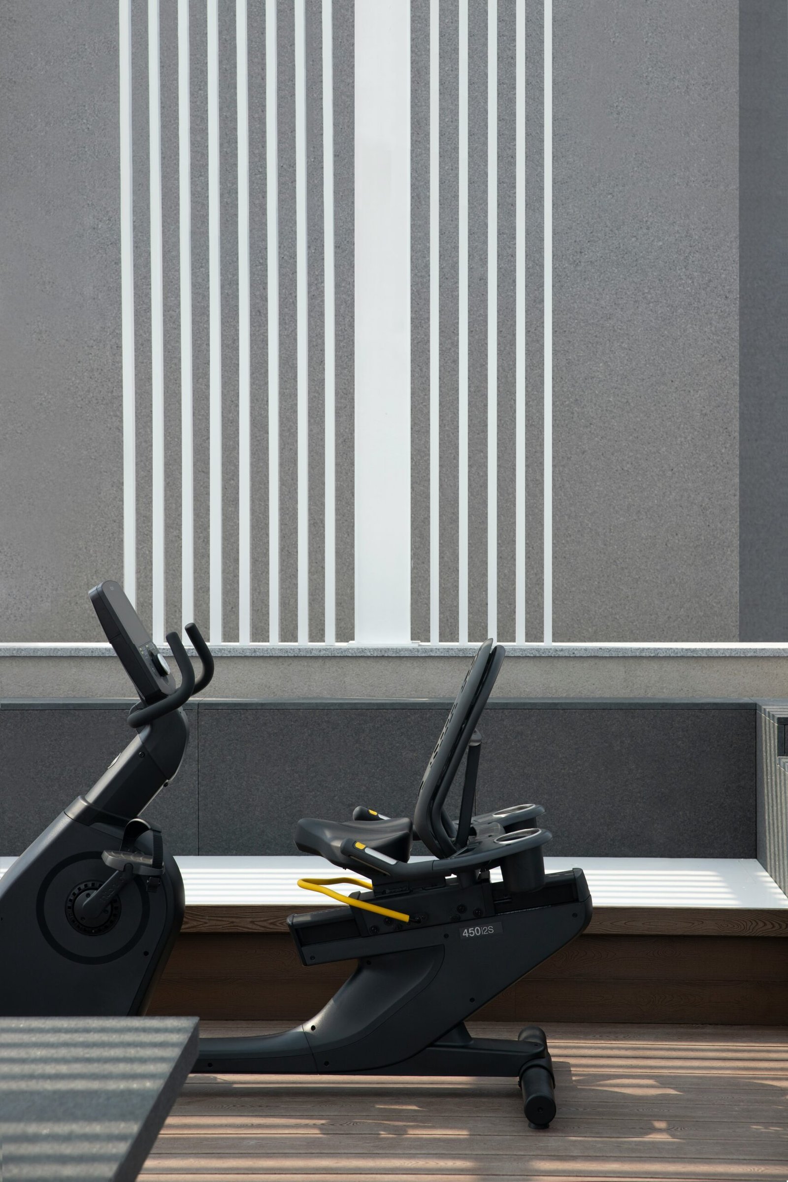 a couple of exercise bikes sitting on top of a wooden floor